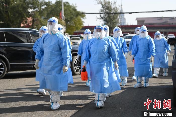 圖為醫(yī)務(wù)人員在封閉小區(qū)做防控工作?！⑽娜A 攝
