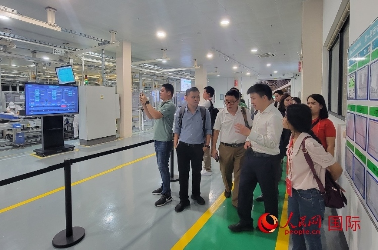 廣汽埃安工作人員向外媒記者進(jìn)行介紹。人民網(wǎng) 寧玉瑛攝