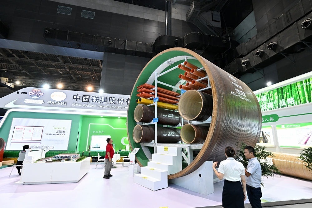 9月2日，在國(guó)家體育館舉行的服貿(mào)會(huì)環(huán)境服務(wù)專題展上，客商在中國(guó)鐵建展位竹纏繞管廊旁了解信息。新華社記者 李鑫 攝