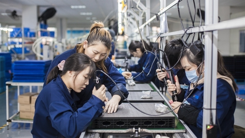 在新亞勝光電的產(chǎn)品線上，工人正進(jìn)行產(chǎn)品組建和安裝布線。受訪者供圖