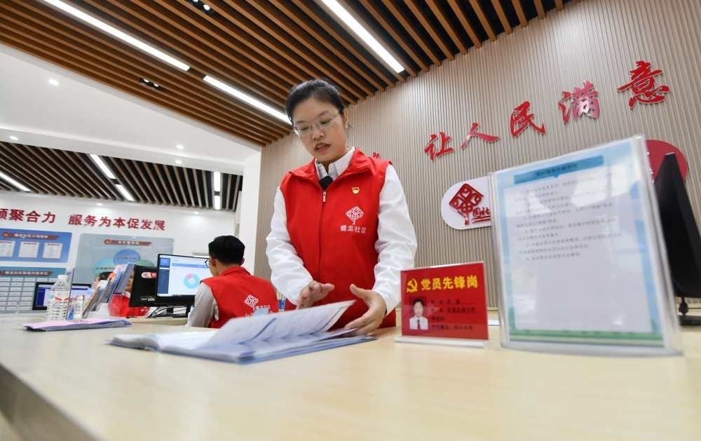 △2023年12月14日，廣西南寧市蟠龍社區(qū)，工作人員在為居民服務(wù)。