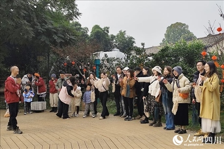 葉科（左一）給前來參與活動的“柑爸柑媽”介紹生態(tài)種植果。人民網(wǎng)記者朱虹攝