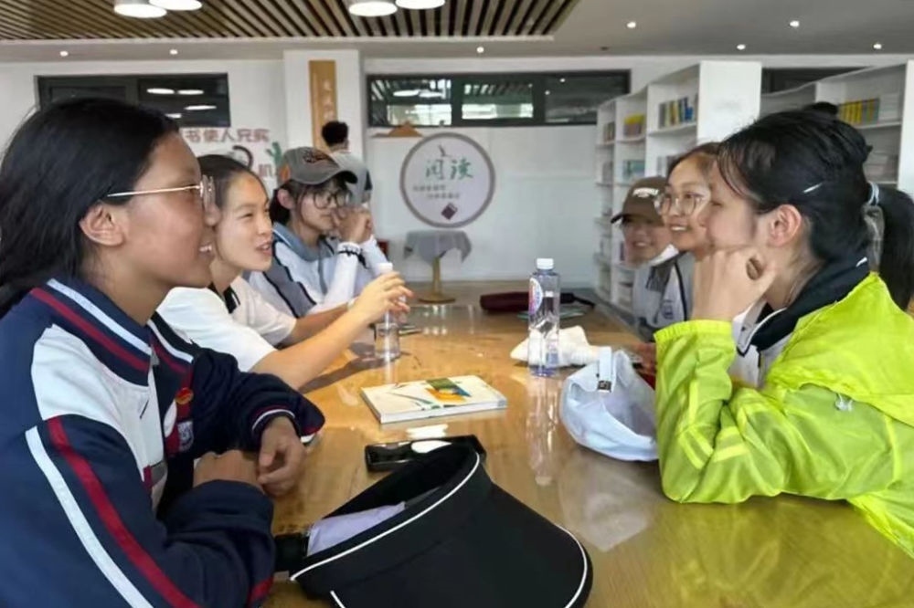 2023年7月10日，在果洛西寧民族中學(xué)，上海市大同中學(xué)學(xué)生（右）與果洛西寧民族中學(xué)學(xué)生交流。新華社發(fā)（果洛州教育局供圖）
