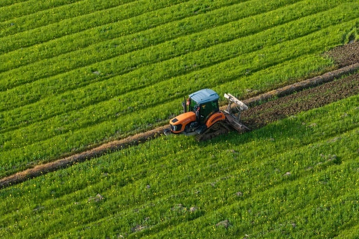 2024年3月19日，在湖南省常德市鼎城區(qū)謝家鋪鎮(zhèn)港中坪村，村民駕駛農(nóng)機(jī)翻耕田地（無人機(jī)照片）。新華社記者 陳思汗 攝