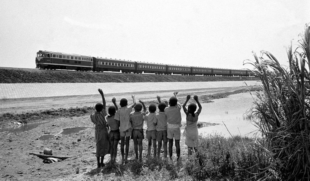 贊比亞魯西瓦西湖畔的少年兒童歡迎坦贊鐵路的列車(chē)通到他們的家鄉(xiāng)（1976年攝）。新華社發(fā)