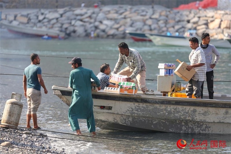 當?shù)厝藗冊谶\送生活物資。人民網(wǎng) 塔里克·易卜拉欣攝